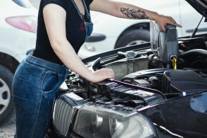 Woman Adding Oil to Car