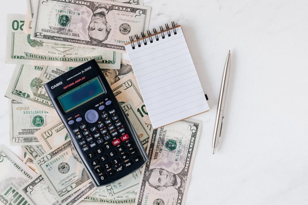 Calculator on Desk With Money