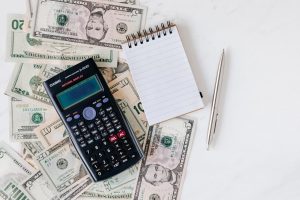 Calculator with Money on Desk